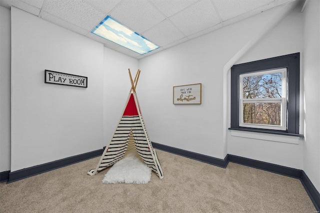 game room with a paneled ceiling and carpet floors