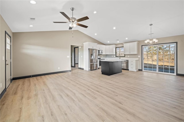 unfurnished living room with lofted ceiling, sink, ceiling fan with notable chandelier, and light hardwood / wood-style flooring