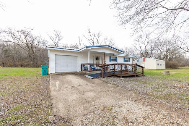 view of front of property featuring covered porch, an outbuilding, and a garage