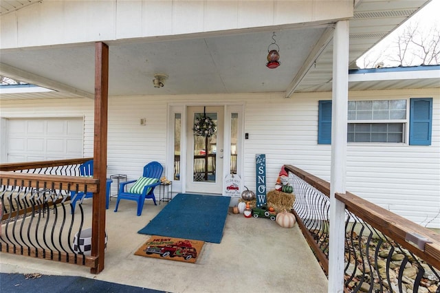 entrance to property with a porch and a garage