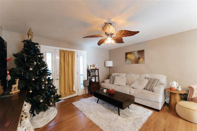 living room featuring ceiling fan and wood-type flooring