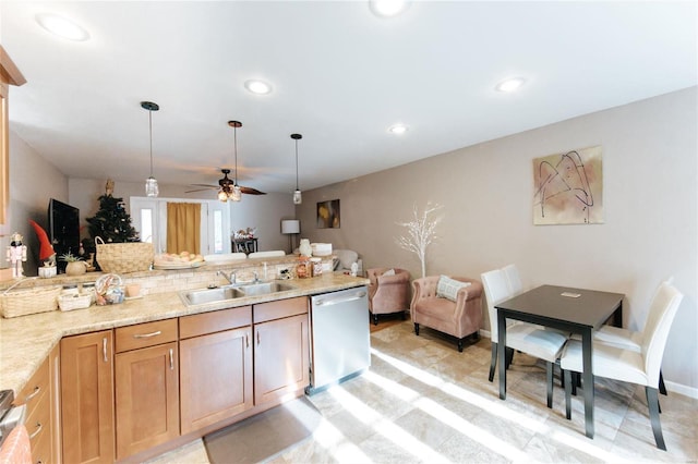 kitchen with light stone countertops, stainless steel dishwasher, ceiling fan, sink, and pendant lighting