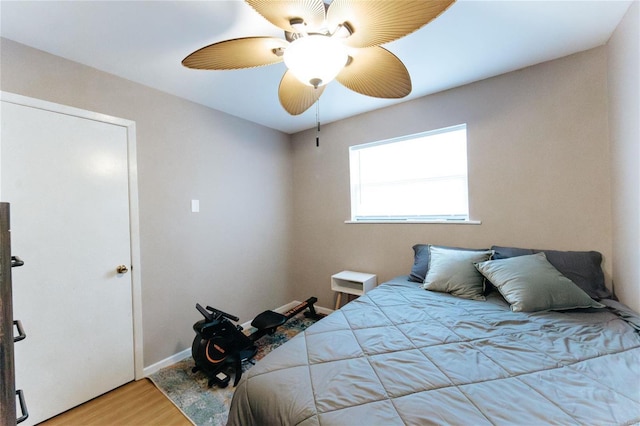 bedroom featuring wood-type flooring and ceiling fan