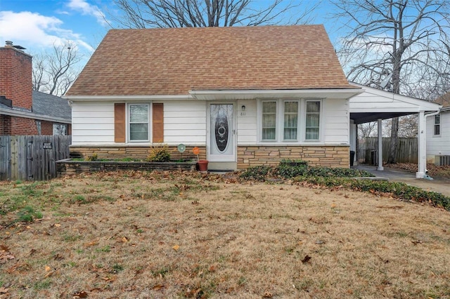 view of front of house with a carport and a front lawn