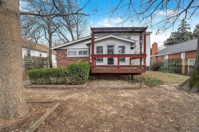 rear view of house featuring a deck