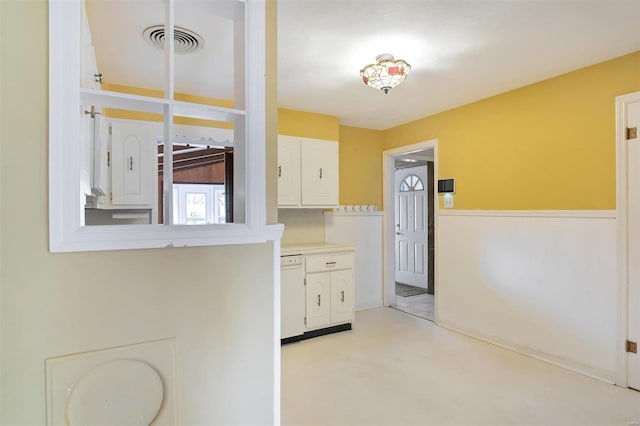 kitchen with dishwasher and white cabinets