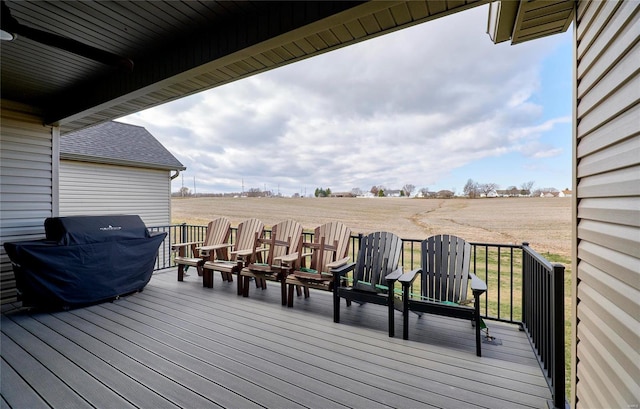 deck with a rural view and grilling area