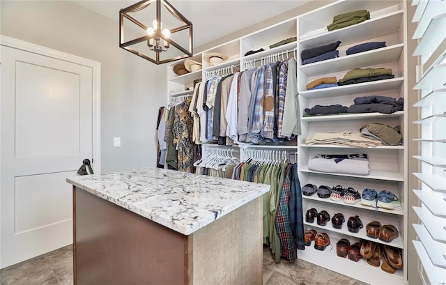 walk in closet featuring a chandelier