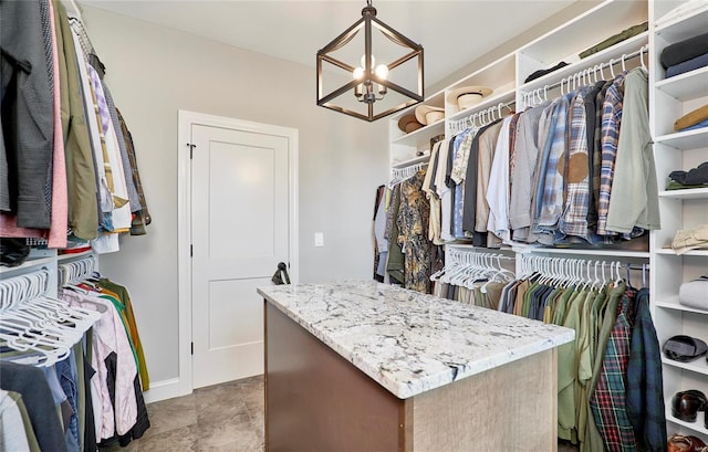 spacious closet featuring a chandelier