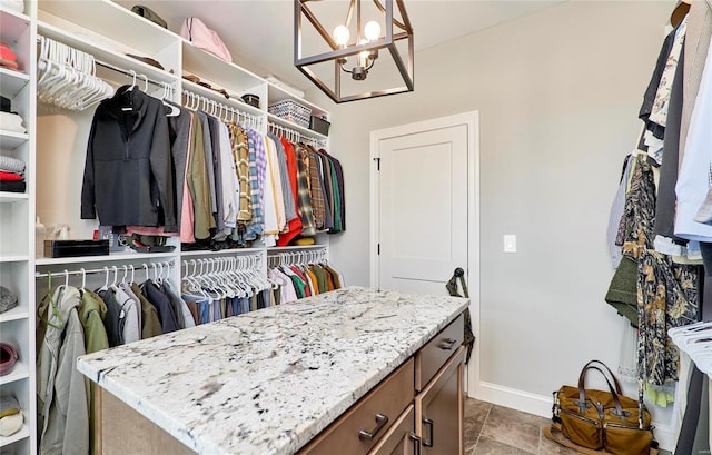 spacious closet featuring a notable chandelier