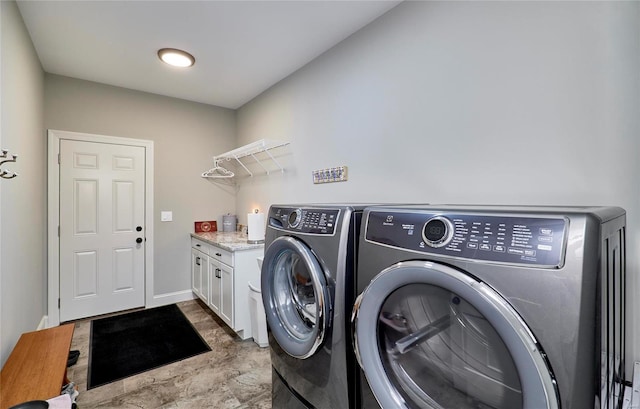 laundry area with cabinet space, baseboards, and separate washer and dryer