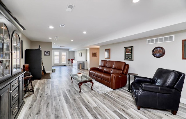 living room with recessed lighting, visible vents, light wood finished floors, and baseboards