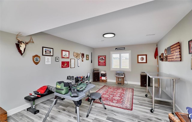 interior space featuring visible vents, baseboards, and wood finished floors