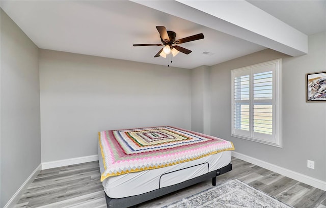 bedroom with a ceiling fan, visible vents, baseboards, and light wood-type flooring