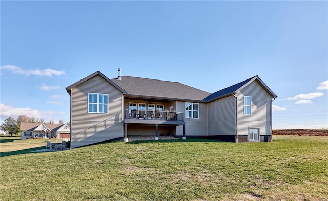 rear view of house with a yard