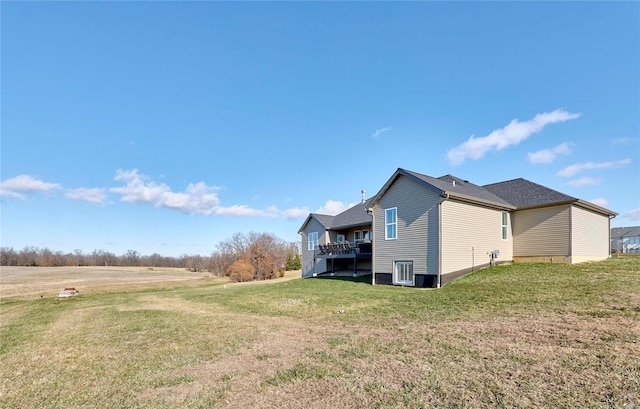 view of side of property with a deck and a yard