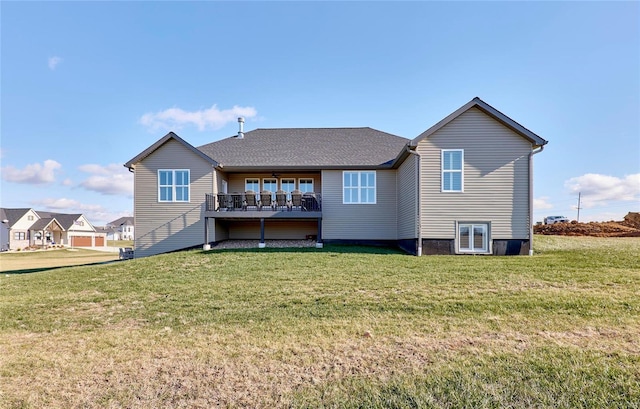 rear view of house with a lawn and a deck