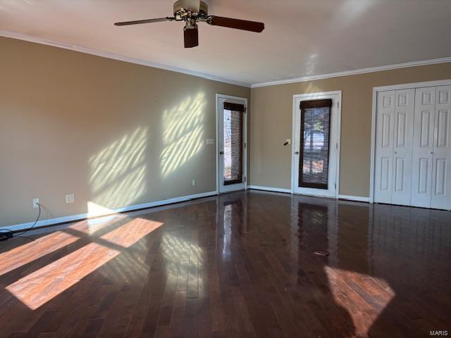 empty room with ceiling fan, dark hardwood / wood-style floors, and ornamental molding