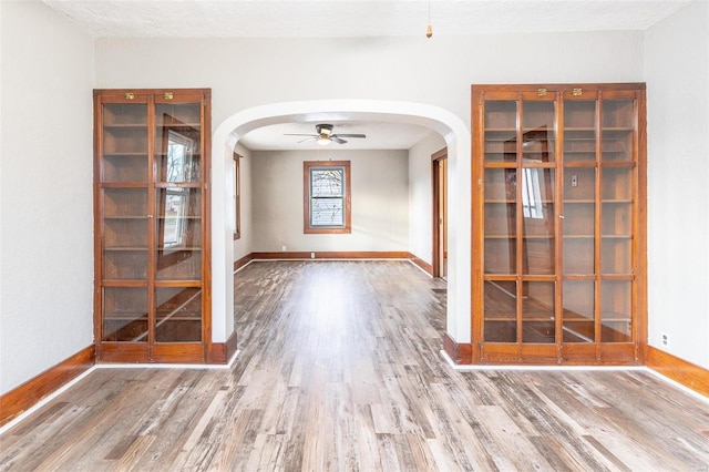 empty room featuring hardwood / wood-style flooring, ceiling fan, and a textured ceiling