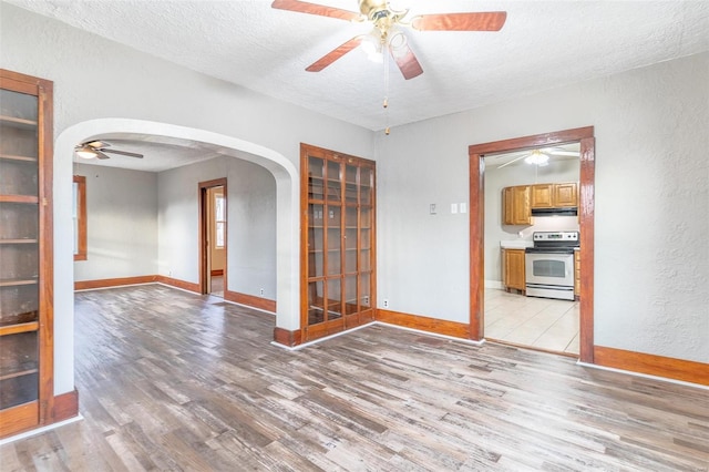 spare room featuring wood-type flooring, a textured ceiling, and ceiling fan