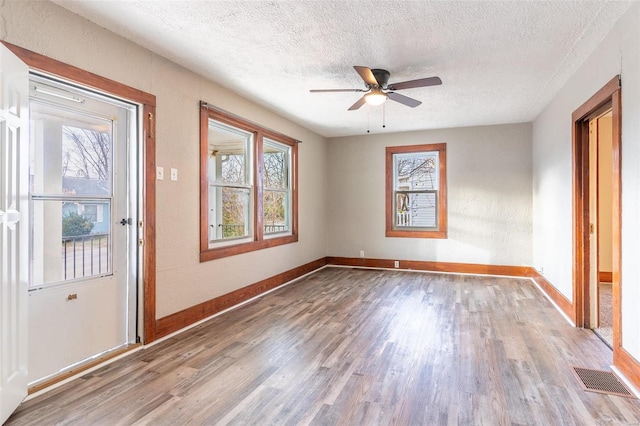 unfurnished room featuring ceiling fan, a textured ceiling, and light hardwood / wood-style flooring