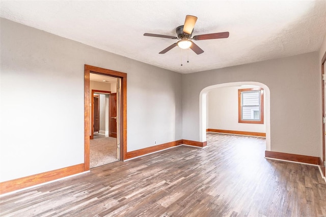 spare room featuring a textured ceiling, ceiling fan, and dark hardwood / wood-style floors