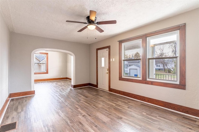 entryway with wood-type flooring, a textured ceiling, and ceiling fan