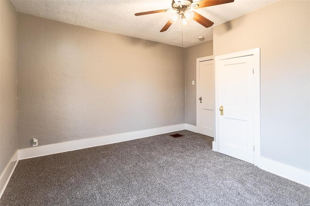 carpeted empty room with ceiling fan and a textured ceiling