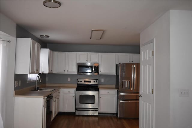 kitchen with white cabinets, dark hardwood / wood-style flooring, stainless steel appliances, and sink