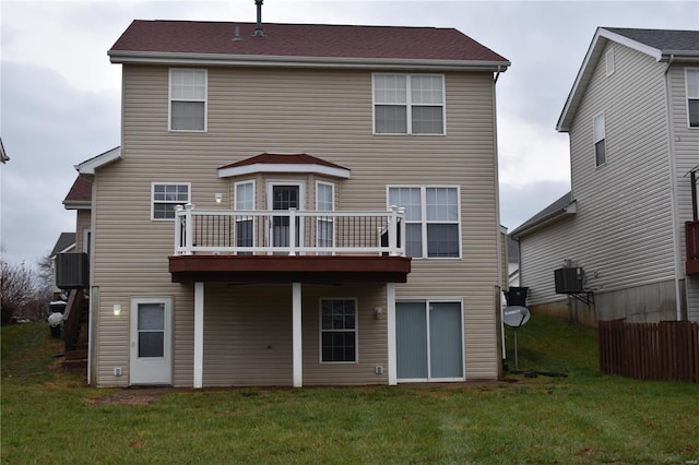 rear view of property with a yard and central air condition unit