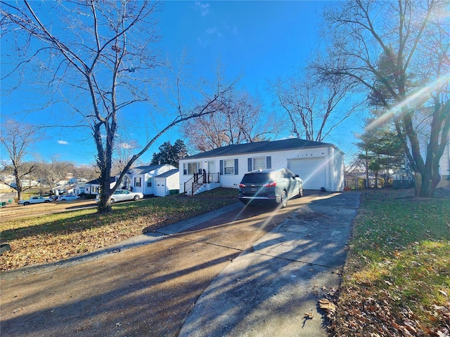 ranch-style home featuring driveway, an attached garage, and a residential view