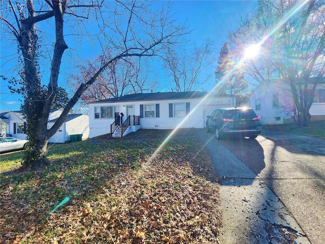 single story home featuring concrete driveway