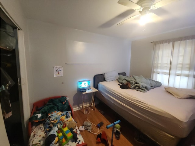 bedroom featuring wood-type flooring and ceiling fan