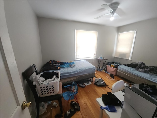 bedroom with a ceiling fan and wood finished floors