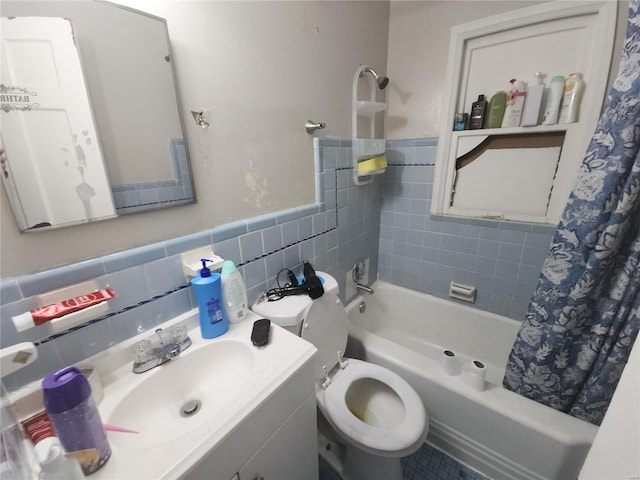 full bath featuring toilet, a wainscoted wall, vanity, tile walls, and shower / bath combination with curtain