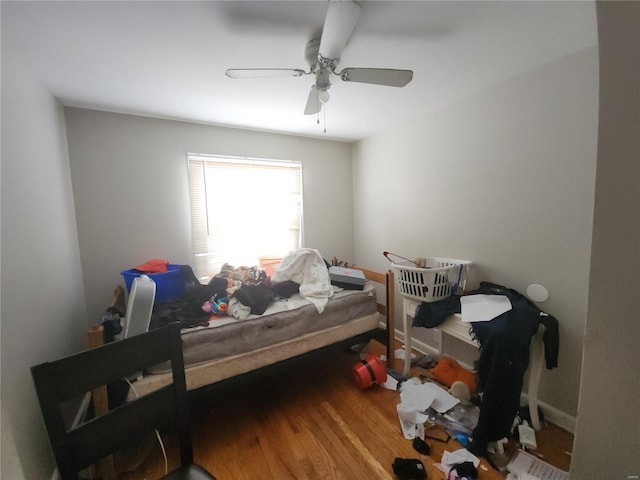 bedroom with a ceiling fan and wood finished floors