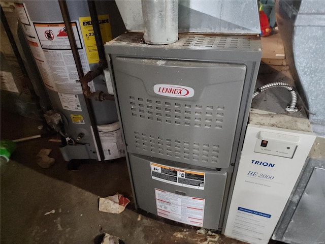 utility room with heating unit and water heater