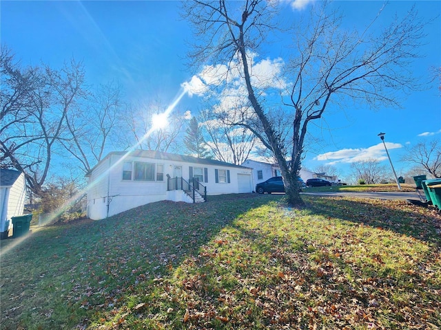 view of front of home featuring a garage and a front yard