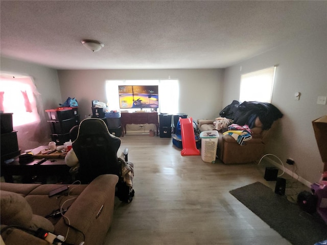 living room featuring a textured ceiling and light wood-type flooring