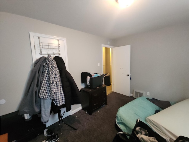 bedroom featuring visible vents and dark colored carpet