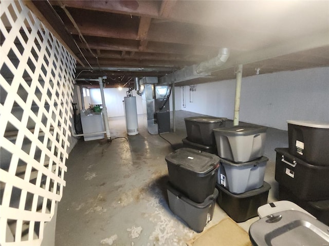 basement featuring heating unit, washer / dryer, and gas water heater