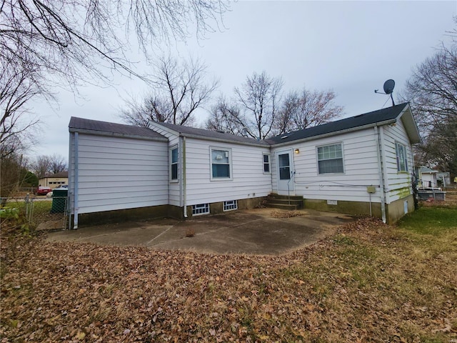 back of house featuring entry steps and a patio