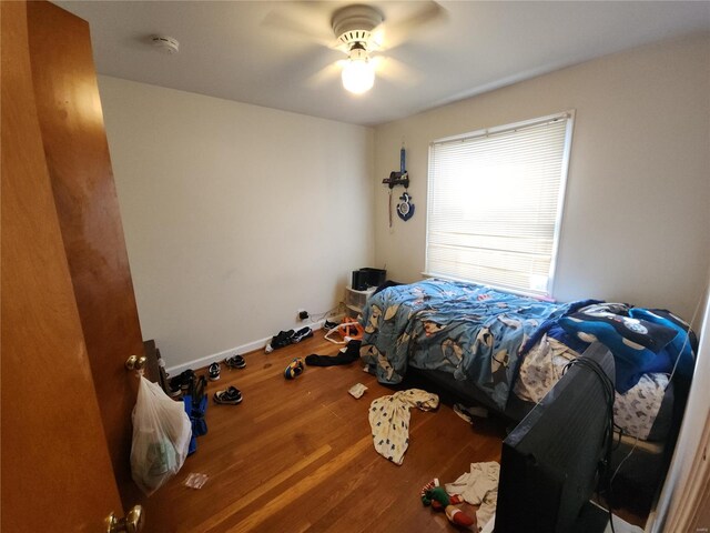 bedroom with wood-type flooring and ceiling fan