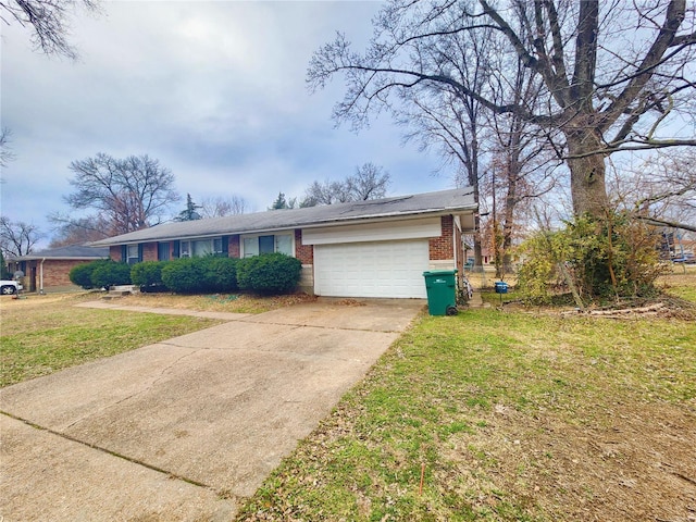 view of front of property with a garage, concrete driveway, brick siding, and a front yard