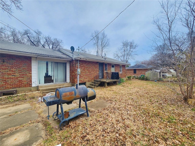 back of house featuring brick siding