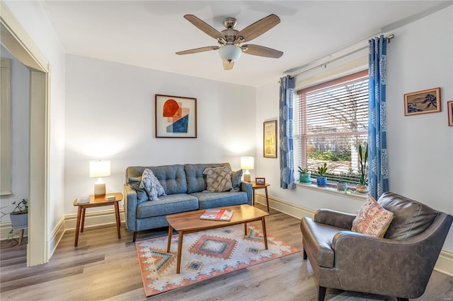 living room with ceiling fan and light wood-type flooring