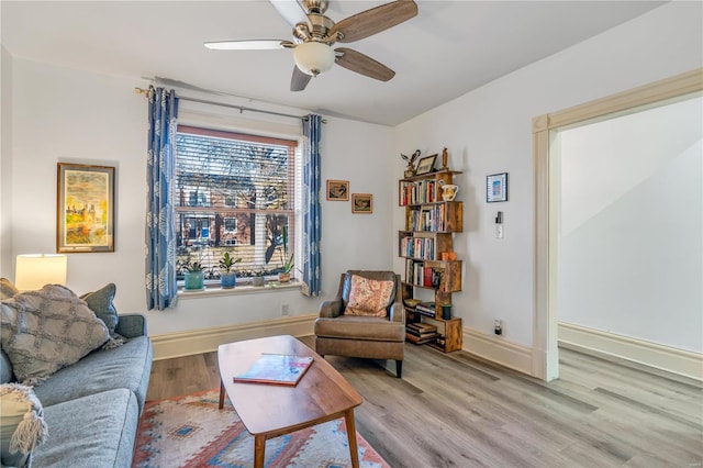 living room with light wood-type flooring and ceiling fan