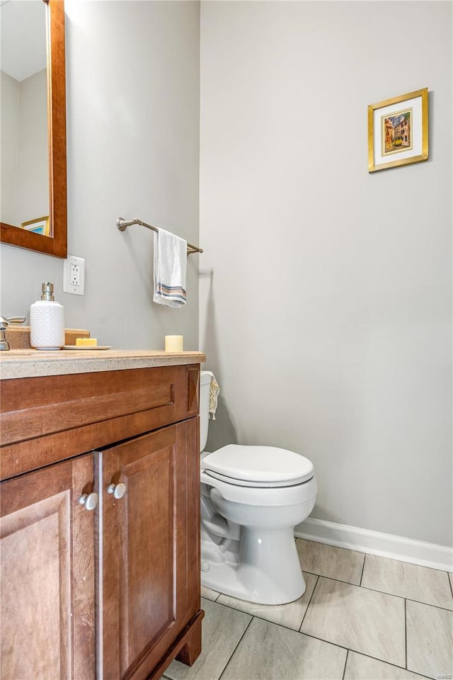 bathroom featuring tile patterned floors, vanity, and toilet