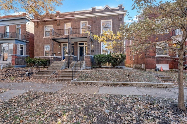 townhome / multi-family property featuring a balcony and a porch