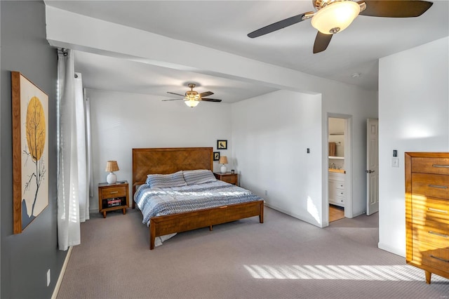 carpeted bedroom featuring ceiling fan and ensuite bathroom